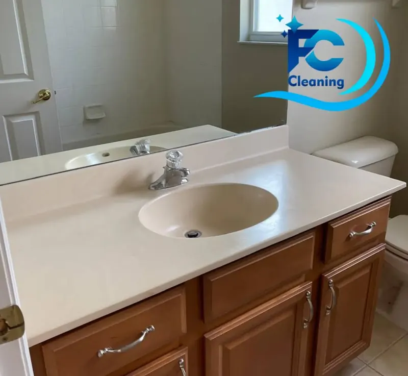 Clean bathroom vanity and mirror after service