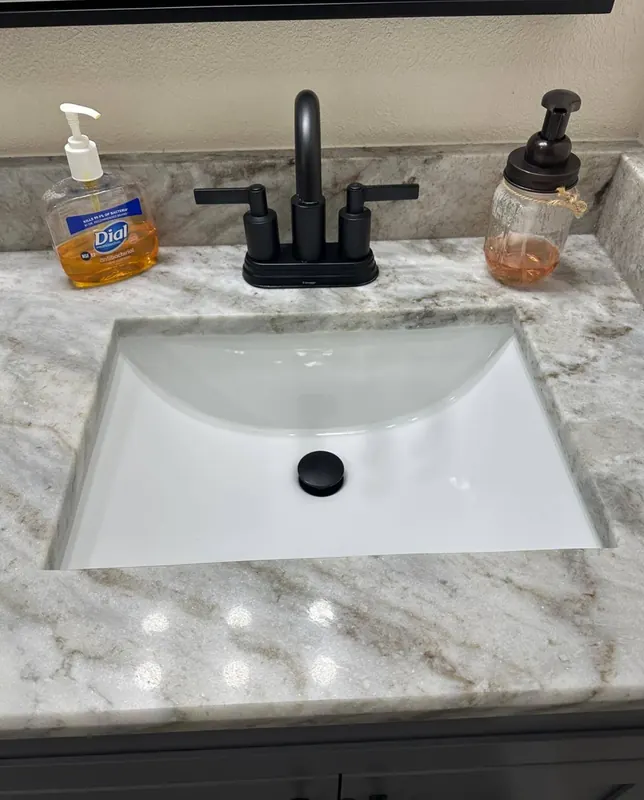 Spotless bathroom sink with polished marble countertop