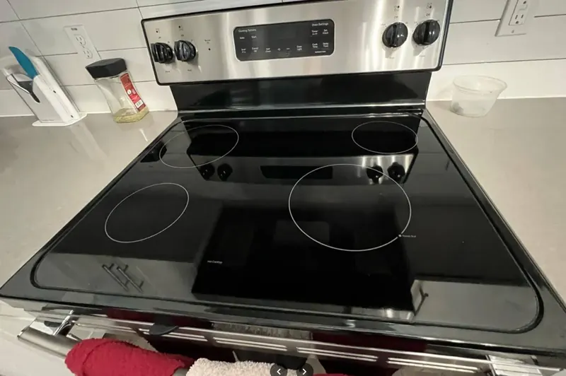 Shiny black glass stovetop after deep cleaning